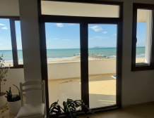 “Sea view from Qerret apartment balcony” “Spacious living room in Qerret apartment for sale”