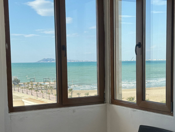 “Sea view from Qerret apartment balcony” “Spacious living room in Qerret apartment for sale”
