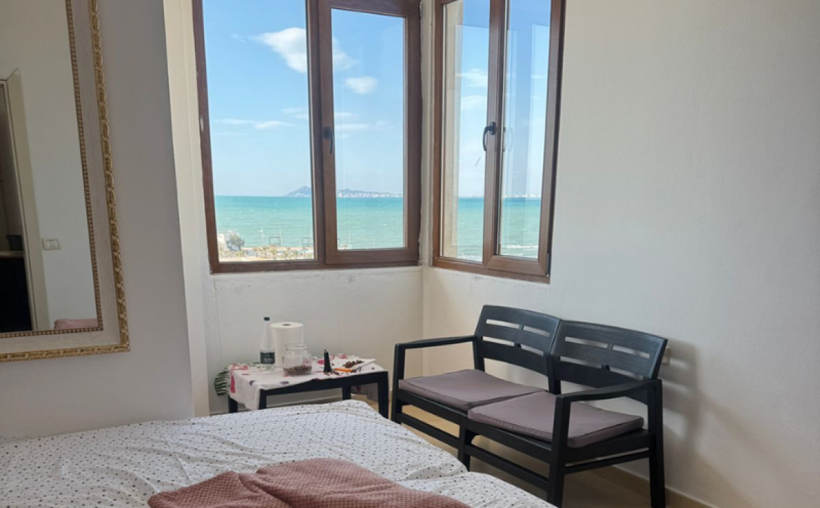 “Sea view from Qerret apartment balcony” “Spacious living room in Qerret apartment for sale”