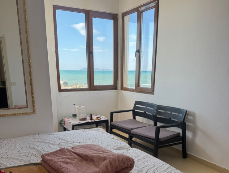 “Sea view from Qerret apartment balcony” “Spacious living room in Qerret apartment for sale”