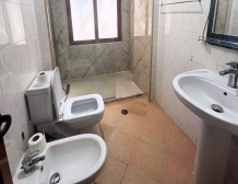 Apartment 2+kk for sale in Mali i Robit, Durrës, living room with kitchen Bedroom in seaside apartment for sale in Durrës, Albania Bathroom in 2-bedroom apartment Mali i Robit Balcony view from apartment in Durrës near the sea Exterior building 4th floor apartment Mali i Robit, Durrës Parking area in front of residential building in Durrës