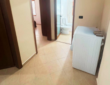 Apartment 2+kk for sale in Mali i Robit, Durrës, living room with kitchen Bedroom in seaside apartment for sale in Durrës, Albania Bathroom in 2-bedroom apartment Mali i Robit Balcony view from apartment in Durrës near the sea Exterior building 4th floor apartment Mali i Robit, Durrës Parking area in front of residential building in Durrës
