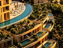 Modern Mediterranean architecture and cascading green balconies at Terrarosa Residence for sale in Borsh